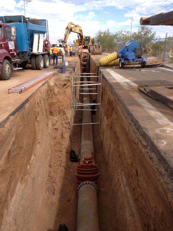COP 24 inch CMAR Machinery and staff installing large pipe underground