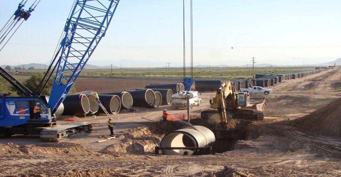 Crane lowering pipe Crane lowering pipe into a hole