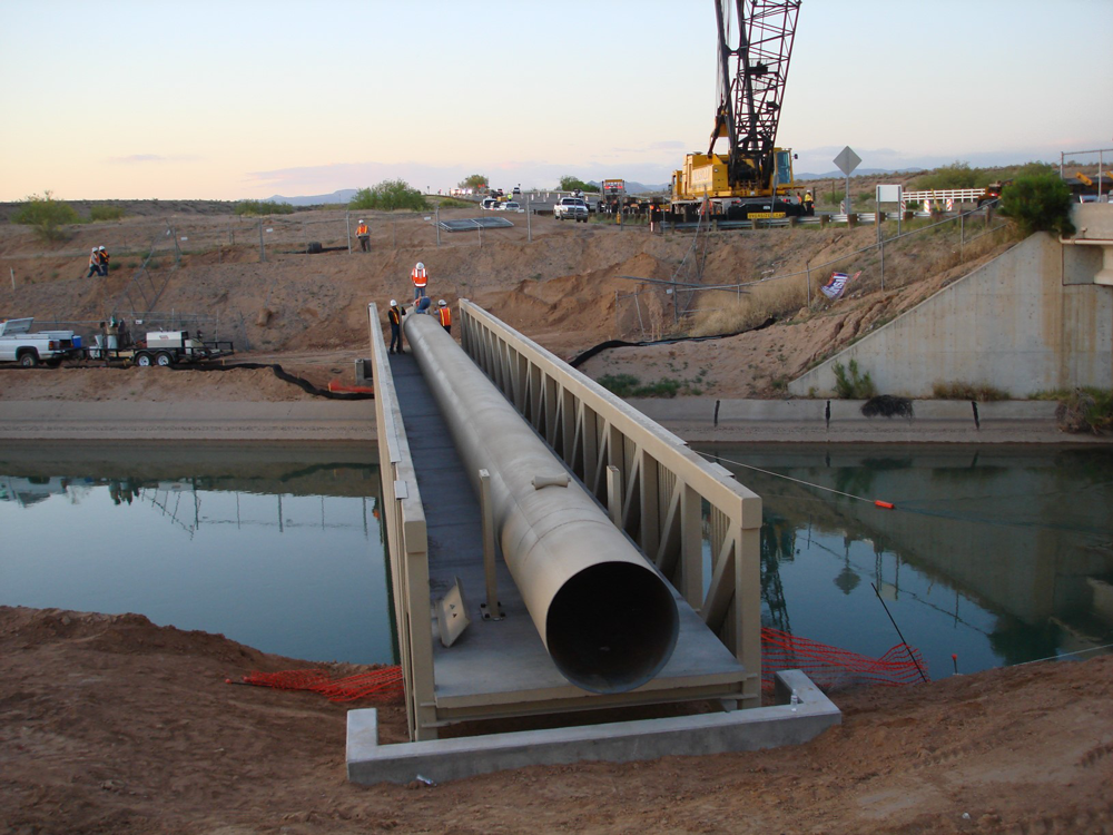 Large pipe on bridge over river