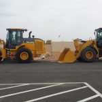 bulldozers packed in a packing lot