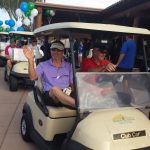 Three golf carts following each other and out of frame