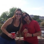 Two ladies with drinks on their hands