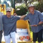 Four people having fun by construction equipment