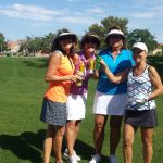 Four ladies wearing gold gear